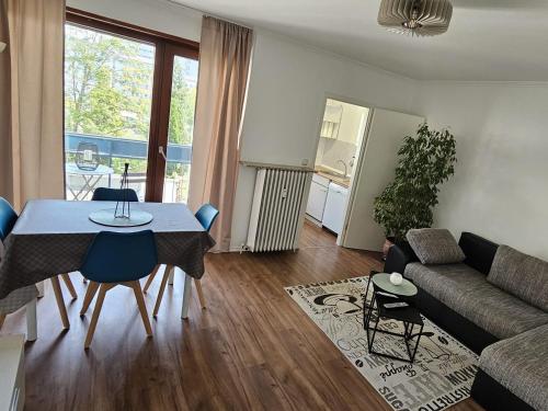 a living room with a table and a couch at Central-Apartment-Adria in Saarbrücken