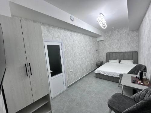 a bedroom with a bed and a tv in it at BEERloga in Samarkand