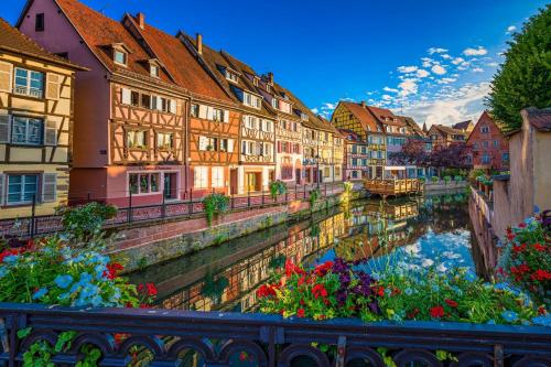 a view of a river in a city with buildings at Gîte Mozart - Marché de Noël in Colmar