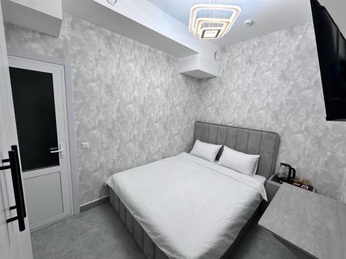 a bedroom with a bed and a television in it at BEERloga in Samarkand