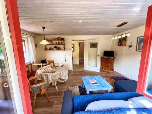 a living room with a blue couch and a table at Ferienhaus Robin in Titisee-Neustadt