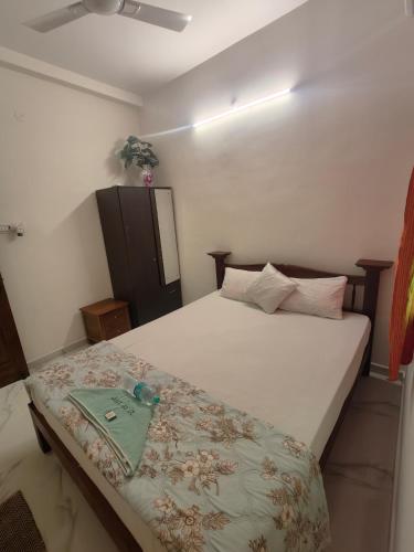 a bedroom with a bed with a tray on it at Buddha Home stay in Mahabalipuram