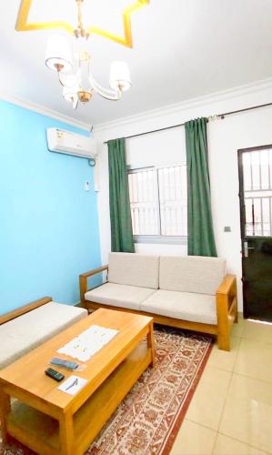 a living room with a couch and a coffee table at Mike's HOUSE in Yaoundé