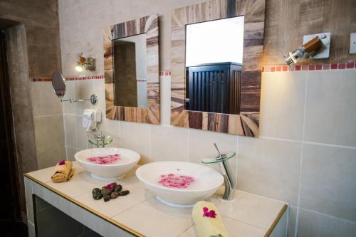 a bathroom with two white bowls on a counter at Maison Lovasoa in Antananarivo