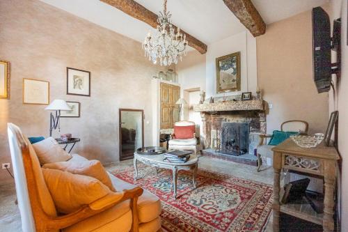 a living room with a couch and a fireplace at Luxurious Provencal Village House, Walk to Village Pool in Rustrel