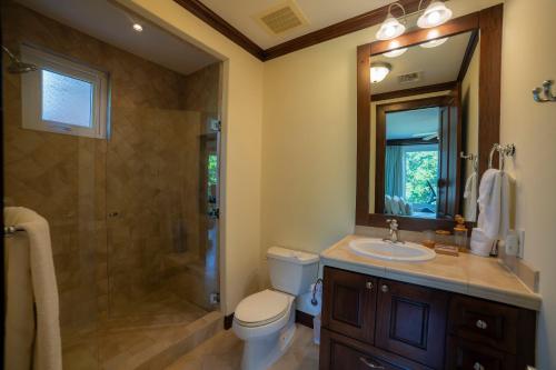 a bathroom with a toilet and a sink and a shower at AltaVista 2C 3 bdr Ocean View in Los Suenos in Herradura