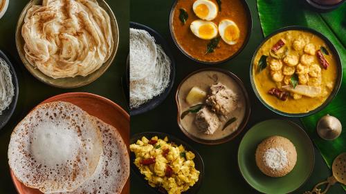 a table topped with bowls of different types of food at Hamlet Beach Villas Alleppey in Alleppey