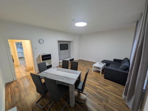 a living room with a table and a couch at Voll eingerichtete Wohnung in Geilenkirchen in Geilenkirchen