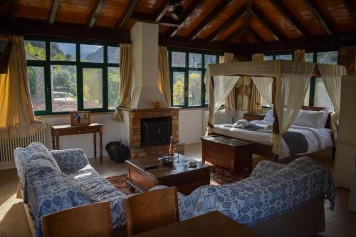 a living room with a bed and a couch at Muntenia Inn Apartments and Suites in Kalavrita