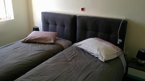 a bed with two pillows on it in a room at B1 Apt Mytilini in Mytilene