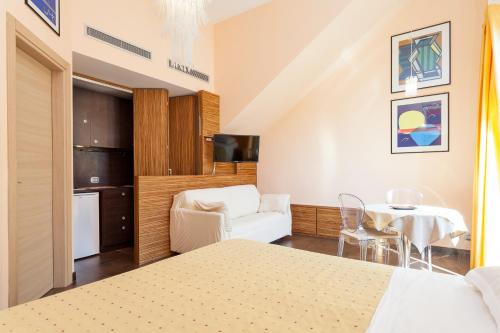 a bedroom with a bed and a table and a chair at Villa Solaria in Massa Lubrense