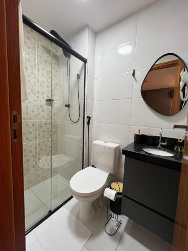 a bathroom with a toilet and a glass shower at Studio Moderno com automação e vista incrível in Juiz de Fora