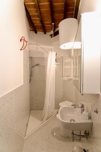 a bathroom with a toilet and a sink at Palazzo Palloni Boutique Apartment in Sorano