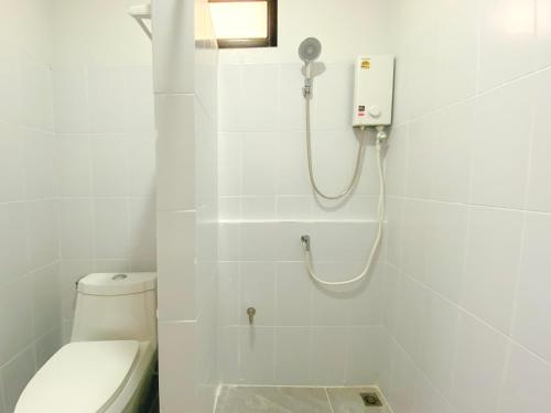 a white bathroom with a shower and a toilet at Panoramic Seaview New Bungalow in Salad Beach
