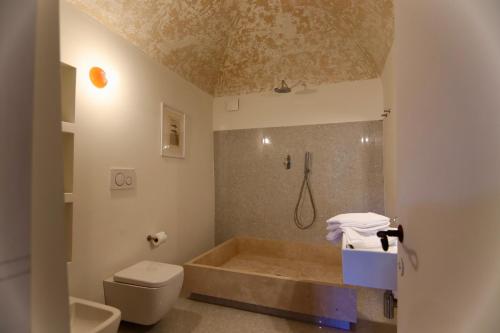 a bathroom with a tub and a toilet at Palazzo Palloni: Piano Nobile in Sorano