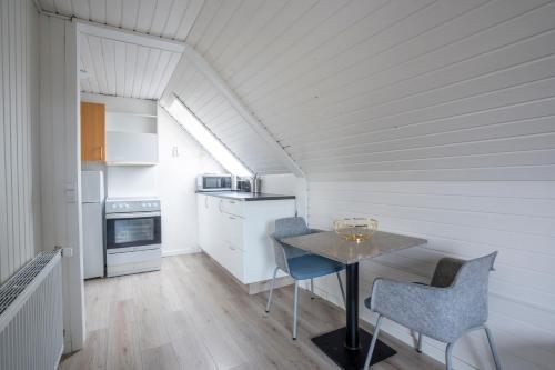 a small kitchen with a table and two chairs at City Apartments in Holstebro