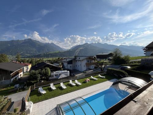 a view of a swimming pool with lounge chairs and mountains at Select Apartment TOP 8 Kaprun Fürth by Jara in Piesendorf