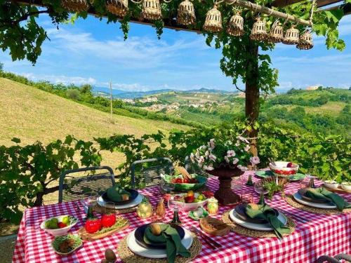 a picnic table with food on a red and white checked table cloth at Tramontana Casetta in Castilenti