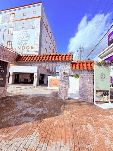 a building with a brick courtyard in front of a building at hotel lindos ホテルリンドス in Okayama