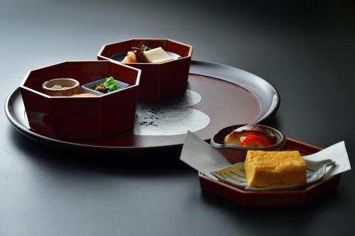 two containers of food on a plate on a table at Okutsusou in Kagamino