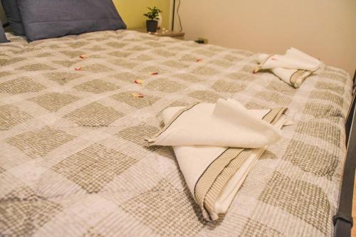 a bed with white towels on top of it at La Corte Segreta - Dimora nel cuore di Urbino in Urbino