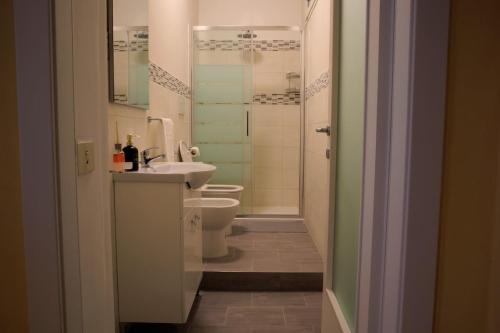 a bathroom with a toilet and a sink and a shower at La Corte Segreta - Dimora nel cuore di Urbino in Urbino