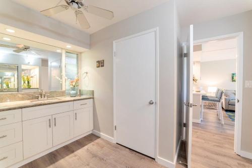 a bathroom with a sink and a mirror at Eldorado E104 · Spacious 1BD wPool at Kaanapali in Kahana