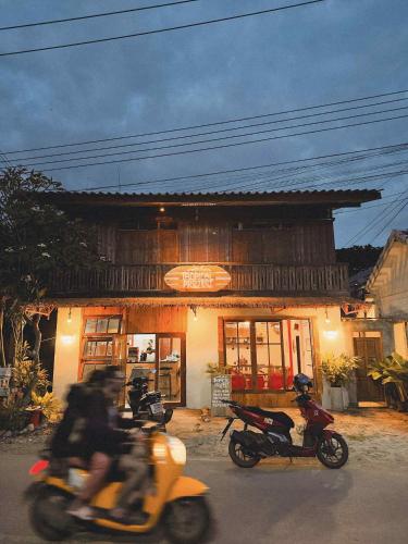 two motorcycles are parked in front of a restaurant at Tropical Project in Pai in Pai