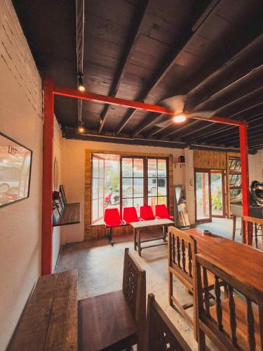 a living room with red chairs and a table at Tropical Project in Pai in Pai