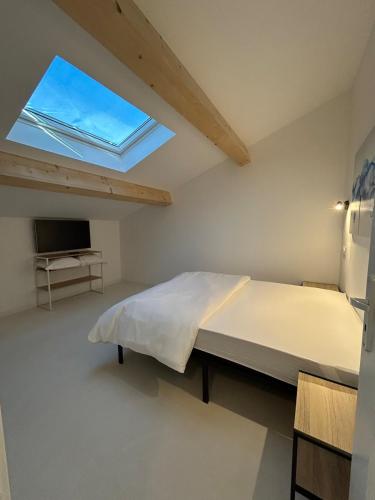 a bedroom with a large bed and a window at 5 bedroom house, office, laundry room in Colomars