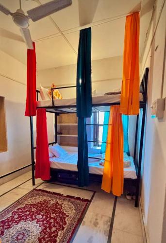 una habitación con dos literas con cortinas coloridas en Hotel Heaven In Jaisalmer, en Jaisalmer