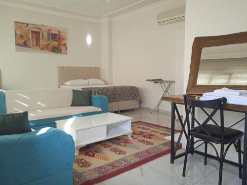 a living room with a couch and a table at Derin park otel in Sanlıurfa