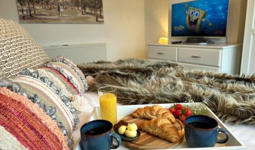a table with a tray of food on a bed at Beresford Cottage in Skegness