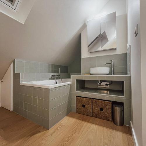 a bathroom with a sink and a bath tub at John in Étaples