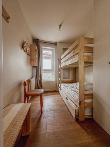 a bedroom with a bunk bed with a chair and a desk at John in Étaples