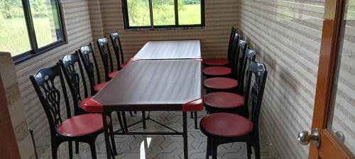 a table and chairs in a room with a table at Sandhyamalati Homestay and Picnic Ground 