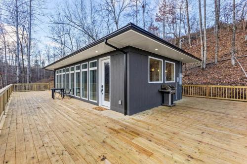 a large deck with a black house on it at Primrose - Cave Run Lake OR Red River Gorge KY in Wellington