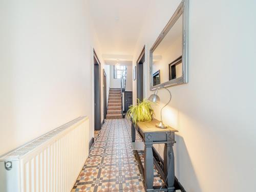 a hallway with a table with a lamp on it at Airyhemming Farm in Glenluce