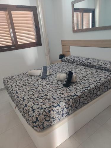 a bed in a room with two pillows on it at El dulce in Pulpí