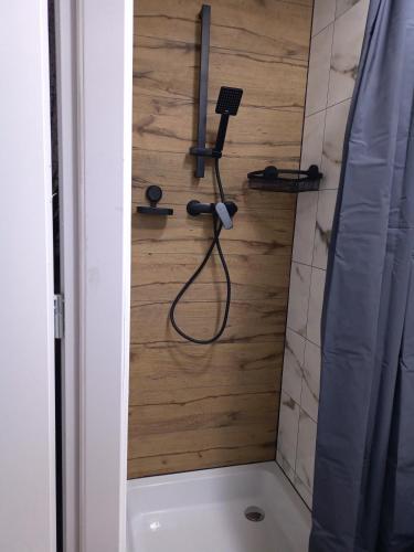 a bathroom with a shower with a shower head at Giżycko Studio Apartament in Giżycko