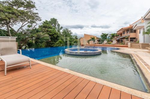 una imagen de una piscina en una terraza de madera en Peaceful Escazu Getaway with Pool, Wi-Fi & Work Space, en Santa Ana