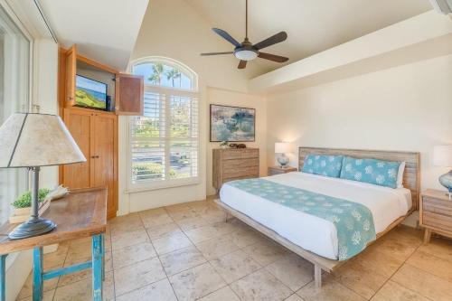 a bedroom with a bed and a ceiling fan at Palms at Wailea 2108 · PAW 2108 Remodeled Wailea Condo w AC Infi in Wailea