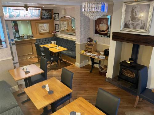 een restaurant met tafels en een open haard bij The Libra - Adults Only B&B with guaranteed carpark in Blackpool