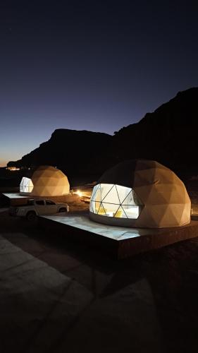 瓦迪拉姆Rum Paradise luxury camp的夜里，桌子上摆着两座圆顶建筑。