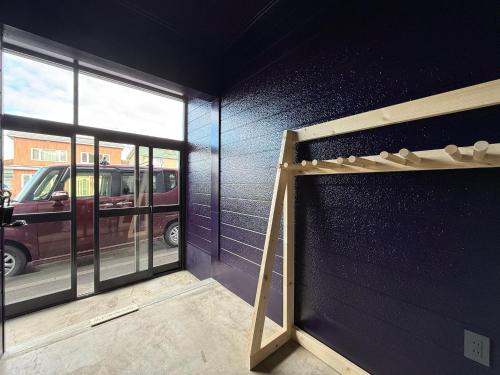 a garage with a black wall and a garage door at The Lobs 5, Rusutsu in Kimobetsu