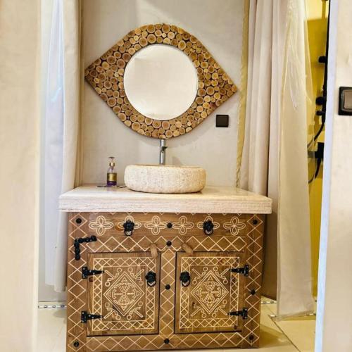 a bathroom with a sink and a mirror at Ahlam luxury camp in Merzouga