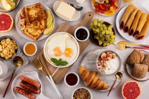 a table full of breakfast food with eggs and bread at Grand Pearl Hotel in Lahore