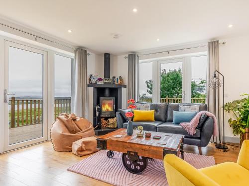a living room with a couch and a fireplace at Go Ye Cottage in Leurbost