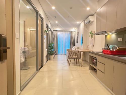 a kitchen with a sink and a dining room at The Song Premium Apartment - Căn Hộ Du Lịch Biển - Anh Khoa Homestay in Vung Tau