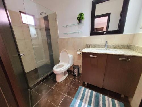 ein Badezimmer mit Toilette, Dusche und Waschbecken in der Unterkunft Walk to Downtown Santa Ana, Near Airport, Lush Gardens, Pool, King Bed, Security in Santa Ana